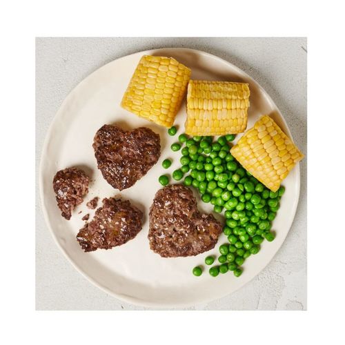 קציצות המבורגר בצורת סמיילי על צלחת.