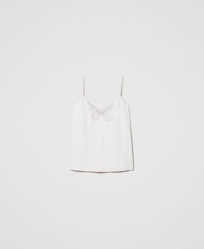 Top with an embroidered butterfly