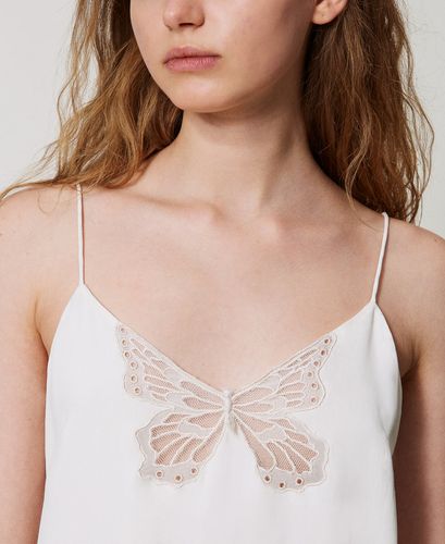 Top with an embroidered butterfly