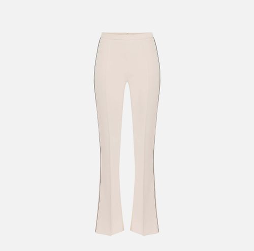 Trousers in crêpe fabric with contrasting piping