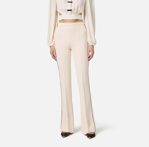 Trousers in crêpe fabric with contrasting piping