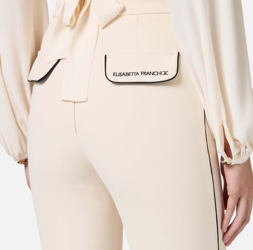 Trousers in crêpe fabric with contrasting piping