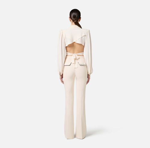 Trousers in crêpe fabric with contrasting piping