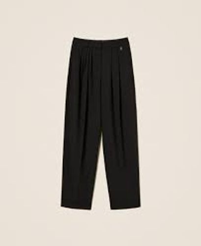 Trousers with asymmetrical pleats