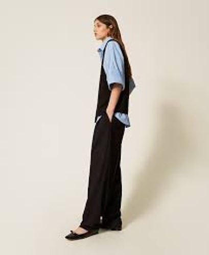 Trousers with asymmetrical pleats