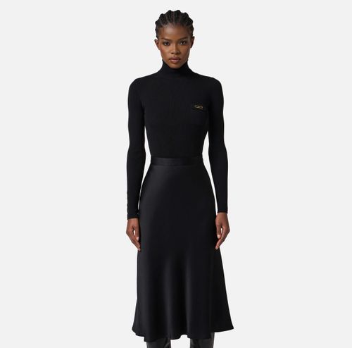 Dress in ribbed knit and satin fabrics with pocket