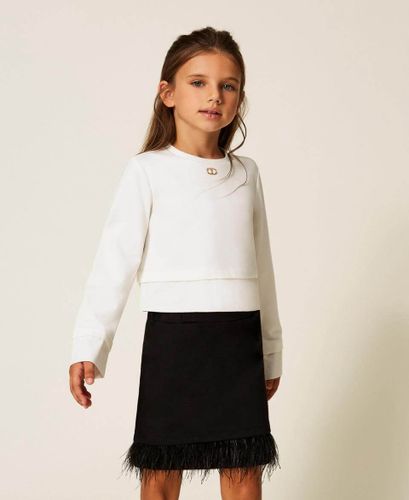 Blouse and skirt with feathers