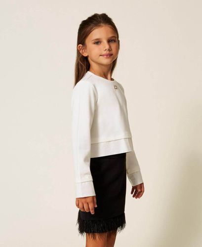 Blouse and skirt with feathers