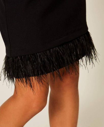 Blouse and skirt with feathers