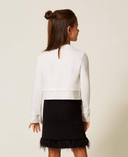 Blouse and skirt with feathers