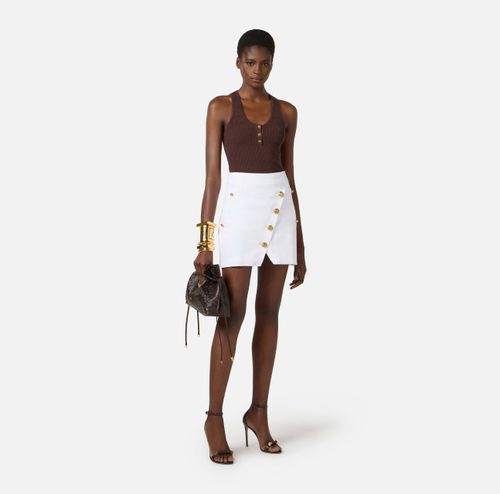 Cotton gabardine miniskirt with jewel buttons
