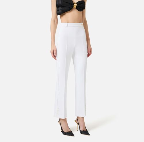 Trousers in double layer stretch crêpe fabric with logo charm
