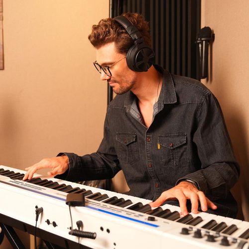 אוזניות OneOdio Studio Max 1 DJ אלחוטיות דגם SX1 - מבט צד על רקע לבן עם עיצוב Over-Ear שחור ומשדר M1 לשיהוי נמוך 20ms