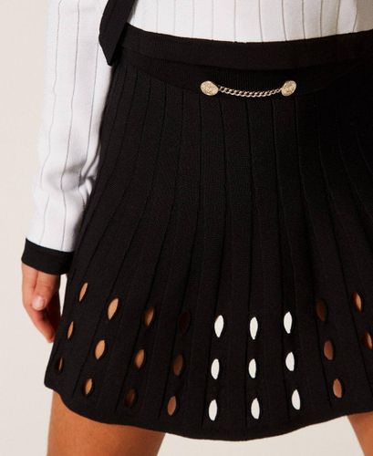 Short openwork knit skirt