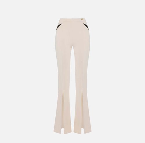 Trousers in lightweight crêpe fabric with cut-outs and slits