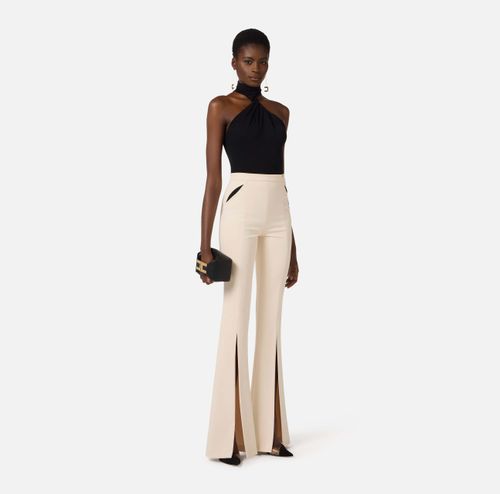 Trousers in lightweight crêpe fabric with cut-outs and slits