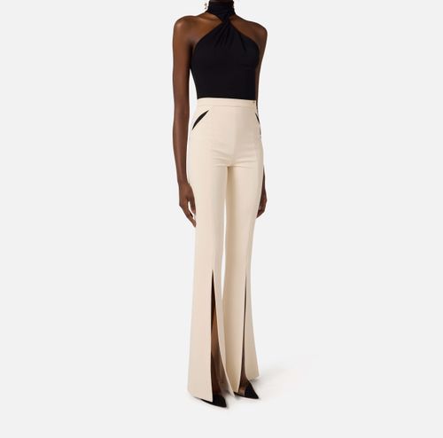 Trousers in lightweight crêpe fabric with cut-outs and slits