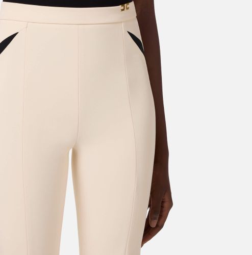 Trousers in lightweight crêpe fabric with cut-outs and slits