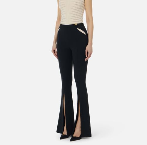Trousers in lightweight crêpe fabric with cut-outs and slits