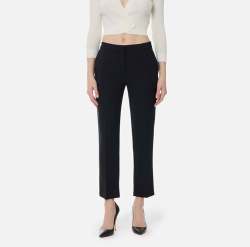 Trousers in lightweight crêpe fabric with logo charm
