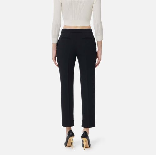 Trousers in lightweight crêpe fabric with logo charm