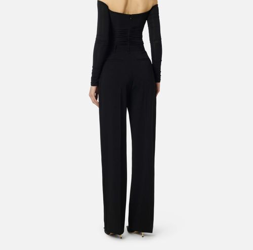 Trousers in lightweight crêpe fabric with logo charm