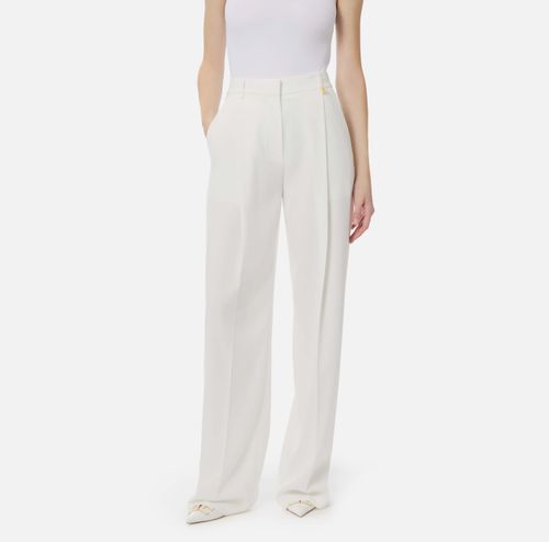 Trousers in lightweight crêpe fabric with logo charm