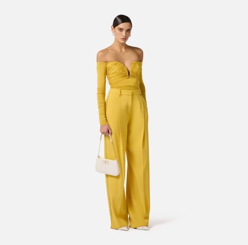 Trousers in lightweight crêpe fabric with logo charm