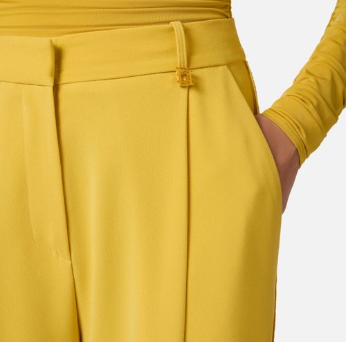 Trousers in lightweight crêpe fabric with logo charm