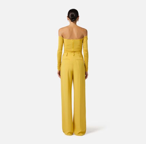 Trousers in lightweight crêpe fabric with logo charm