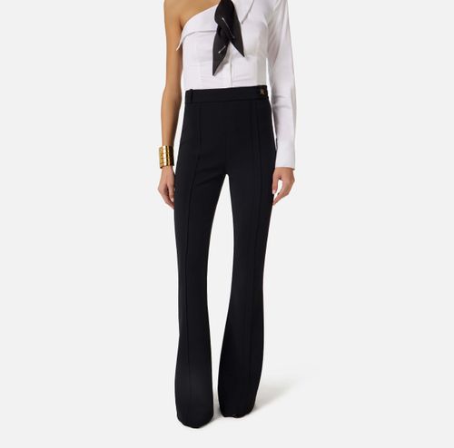 Trousers in double layer stretch crêpe fabric with logo charm