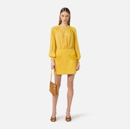 Dress in georgette and bouclé tweed fabrics