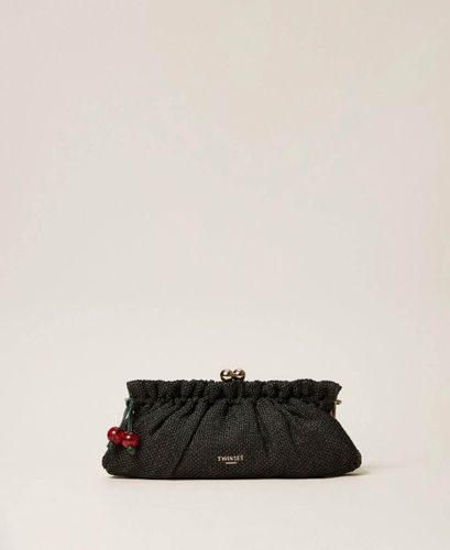 Raffia clutch with charm