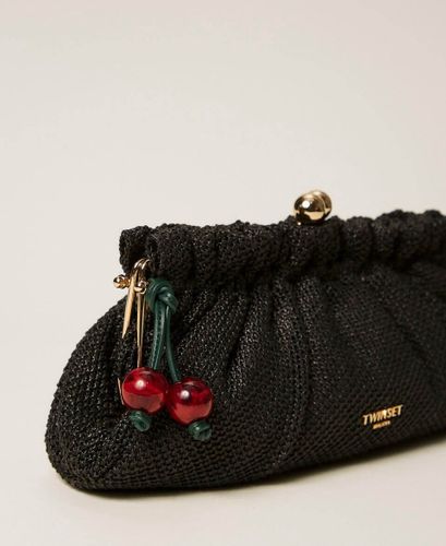 Raffia clutch with charm