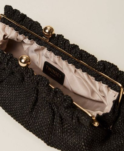 Raffia clutch with charm