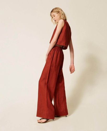 Linen trousers with embroidered logo