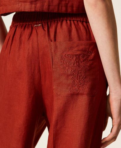 Linen trousers with embroidered logo
