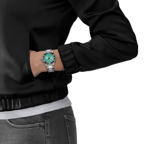 שעון TISSOT דגם T1202101109100 לאישה לוח טורקיז רצועת פלדת אל-חלד בצבע אפור – תמונה 2