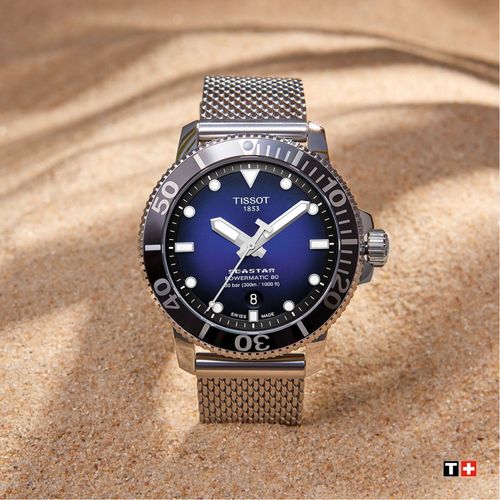 שעון TISSOT דגם T1204071104102 לגבר לוח כחול מדורג רצועת פלדת אל-חלד בצבע אפור