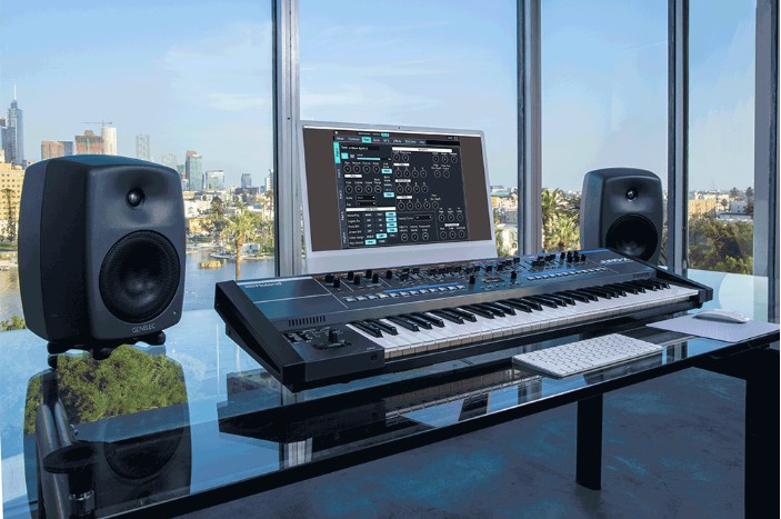 roland juno-x on desktop with speakers and pc screen