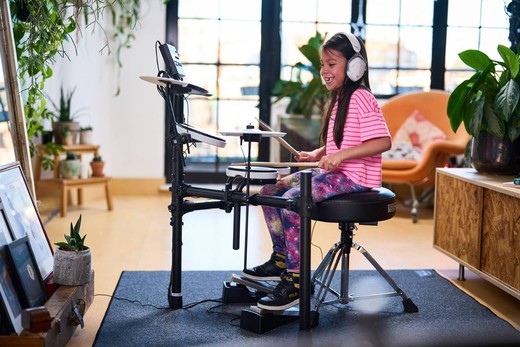 Roland E-Drums TD-02K full kit in room smiling child playing