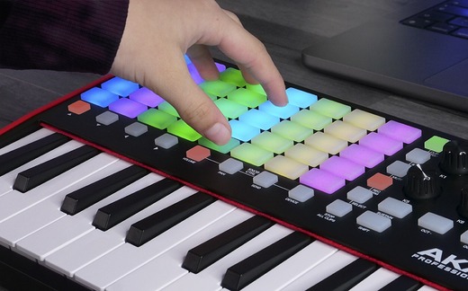 Akai APC Key25 mkII with hand on rgb buttons