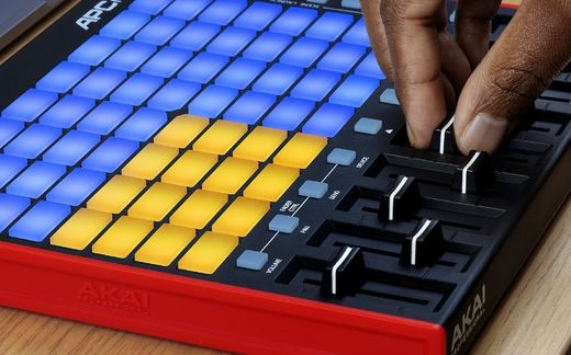 Akai Pro APC mini mk2 with a hand holding a fader