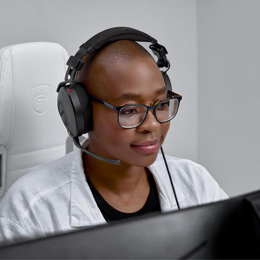 Rode NTH-100M headphones woman infront of a computer