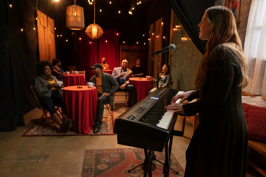 roland fp-e50 woman playing and singing in a small club